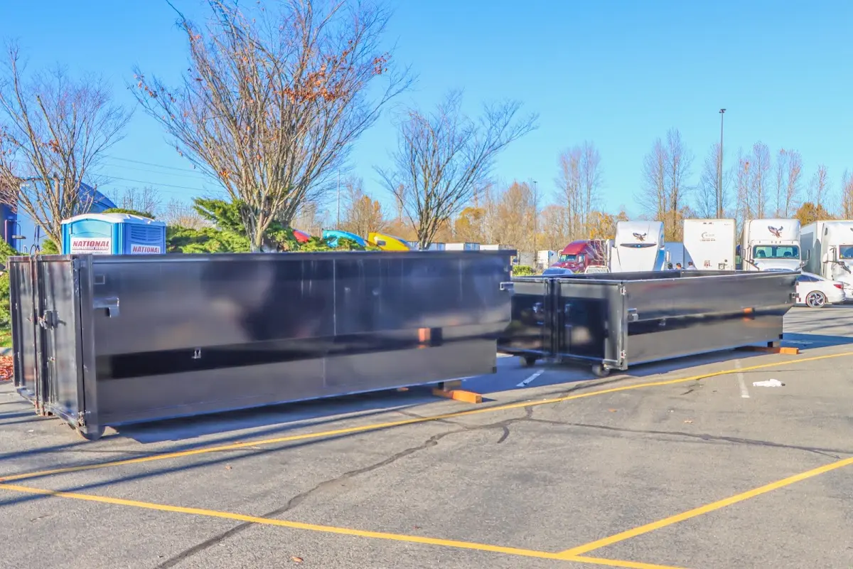 Professional dumpster rental service with roll-off container on residential driveway in Charles Town